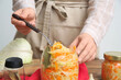 © Pixel-Shot - Woman with tasty fermented cabbage in kitchen. Closeup