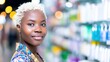 © tashechka - Young woman smiling in a colorful store aisle while shopping