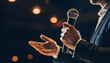 © Malik - Professional Speaker Holding Microphone on Stage