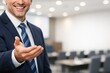 © Jafree - Smiling man in business suit extending hand, offering a handshake or presenting copy space. Professional gesture of welcome, greeting, collaboration, copy space