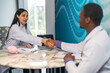 © Art_Photo - Professional doctors shaking hands, happy female physician and african male partner making agreement in hospital office, medical teamwork, diversity, cooperation and successful contract deal concept