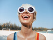 © SHOTPRIME STUDIO - Bright portrait of a joyful woman at the beach, wearing beaded sunglasses and a colorful swimsuit, lit by sunlit skin and a carefree, vibrant mood.