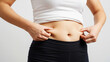 © Tegar Ramadhani - Woman Pinching Her Excess Belly Fat, Worried About Weight Gain and Body Image
