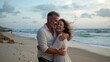 © Babb - Mature caucasian couple embracing on beach at sunset, enjoying romantic moment