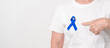 © Jo Panuwat D - Elderly with dark Blue or Navy blue Ribbon for concept of March Colorectal and Colon Cancer Awareness month, May Arthritis awareness, July Juvenile arthritis and Childhood. Health and world cancer day