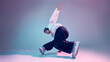 © Lustre Art Group  - Breakdance dancer performing floor balance move in studio with gradient light background. Concept of street dance training, body control, flexibility, modern choreography, and youth culture.