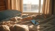 © backup_studio - Smartphone laying on bed in bright early morning sunlight. Cozy bedroom interior with phone left on wrinkled sheet. Leisure weekend concept.