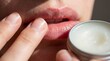 © My Stock - Applying lip balm moisturizing closeup lips skincare product