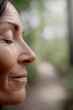 © Asier - Woman closing eyes, showing peace, mindfulness, and healthy aging outdoors