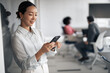 © Jelena - Asian businesswoman using mobile phone in office