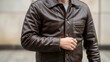 © photoplotnikov - Male adult in brown leather jacket standing outdoors displaying fashionable style and casual attire
