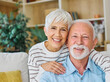 © Lumos sp - Happy active senior couple, portrait of an elderly woman with her husband sitting at home