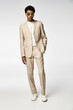 © LIGHTFIELD STUDIOS - Stylish young African American man showcases modern fashion in a trendy studio setting