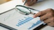 © adaptable_ Lark98A1 - A person examines a financial report through a magnifying glass, emphasizing attention to detail in data analysis.