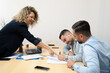 © Carmen - Business people signing contract during collaborative meeting