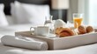 © Anat art - Breakfast Tray Placed on a Bed in a Hotel Room Showing Simple Food Items and Drinks for a Morning Meal
