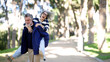 © DMegias - Happy senior couple having fun outdoors, man carrying woman on his back, laughing and sharing a playful moment in a park