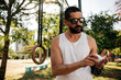 © kleberpicui - Adult man preparing for physical activity in a park before outdoor training. Concepts of fitness routine, self care, preparation, healthy lifestyle and sport motivation.