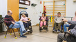 © DMegias - Group of diverse people with disabilities participating in a support meeting or therapy session at a rehabilitation center