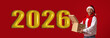 © Prostock-studio - A man wearing a Santa hat and red scarf smiles as he holds a cardboard box in front of large golden numbers indicating the next year. The background is bright red.