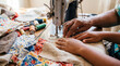 © Aurora Aesthetics - African american grandmother teaching granddaughter sewing family support generational craft background copy space hobby tradition domestic life
