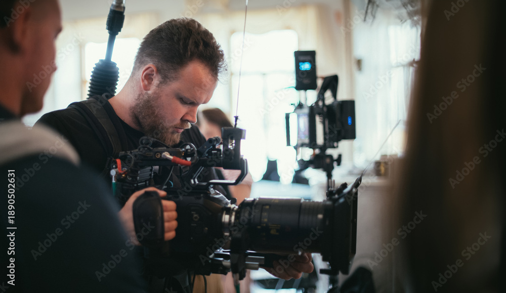 The director of photography with a camera on the set. A professional ...
