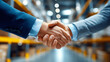 © Nataliya - Warehouse logistics partnership handshake, faceless business gesture, industrial collaboration, supply chain agreement, professional cooperation, defocused facility background, wit