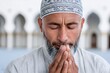 © Lubos Chlubny - Muslim man praying devotion in a mosque