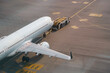 © aapsky - Aircraft departing international apron airport runway. Tow truck push back untitled airplane aerial view plane.