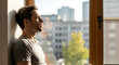 © Felippe Lopes - A man meditates peacefully by a window with a city view