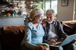 © Geber86 - Smiling senior couple using laptop at home