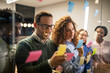 © Miljan Živković - Diverse business team brainstorming ideas using sticky notes