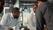© DC Studio - Employees and coworkers discussing business intel and performance metrics in meeting. Multinational company work team reviews reports, forecasts and diagrams to align strategy.