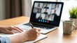 © Andrey - Woman making notes during video conference with team. Remote work concept for online meeting and distant communication. Virtual learning and education.