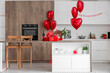 © Pixel-Shot - Interior of stylish kitchen with gifts, wine and heart-shaped balloons. Valentine's Day celebration