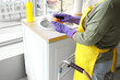 © Pixel-Shot - Woman with walker washing dishes in kitchen, closeup