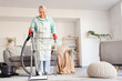 © Pixel-Shot - Mature woman with walker and vacuum cleaner cleaning carpet at home