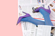 © Pixel-Shot - Young woman in high heels with many newspapers on pink background, top view