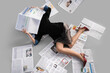 © Pixel-Shot - Young woman in high heels with many newspapers lying on grey background, top view