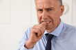 © Pixel-Shot - Worried mature businessman biting nails in office
