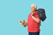 © Pixel-Shot - Senior man with sports bag and fitness mat on blue background