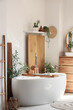 © Pixel-Shot - Interior of stylish bathroom with sink, bathtub, chest of drawers and shelf