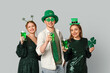 © Pixel-Shot - Happy friends with beer and clover on light background. St. Patrick's Day celebration