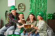 © Pixel-Shot - Group of people with beer sitting at home on St. Patrick's Day