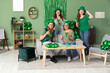 © Pixel-Shot - Group of people with beer at home on St. Patrick's Day