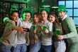 © Pixel-Shot - Group of young people with beer taking selfie in pub on St. Patrick's Day
