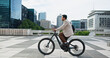 © peopleimages.com - Business, cycling and travel with man in city carbon neutral or eco friendly transportation. Bike, buildings and commute with employee person riding outdoor in urban town for net zero sustainability