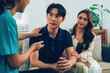 © MIND AND I - Counselor Comforting Asian Man During Home Health Consultation
