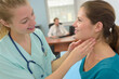 © auremar - physiotherapist stretching neck of a female patient in the clinic