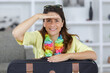 © auremar - young woman at home with suitcase shading her eyes